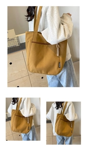 Three-way view of mustard yellow large canvas tote bag with side zipper pocket