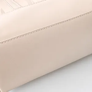 Macro shot of high-quality leather texture and fine stitching on large tote bag
