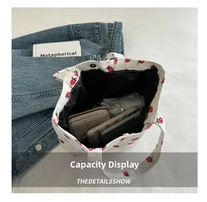 Internal view showing large capacity of the corduroy strawberry tote with daily essentials