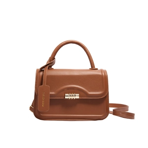 Retro caramel brown leather handbag with embossed wave texture and gold twist lock