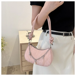 Detail of pink hobo bag with silver chain, pearl charms and unique knotted handle
