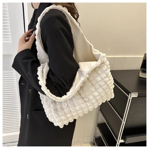 Close-up of white bubble texture fabric on a large capacity shoulder tote bag