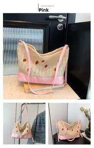 Detail of strawberry pattern straw bucket bag with pink synthetic leather straps