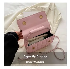 Interior view of pink quilted chain bag showing capacity for phone and small items