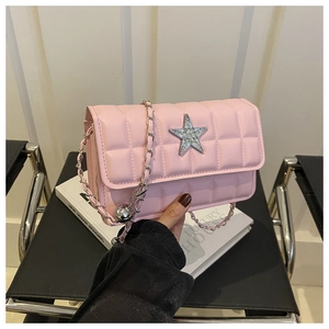 Detailed shot of pink quilted crossbody bag with rhinestone star and silver chain