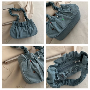 Detail view of light blue denim pleated bag with colorful rhinestones and scrunchie strap
