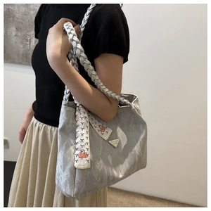 Detail view of silver-grey marble textured tote bag with silk scarf and braided handle