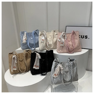 Detailed display of tote bags in six colors with woven handles and decorative scarves