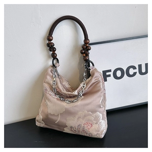Detailed close-up of champagne lace tote bag with floral embroidery and wooden beads
