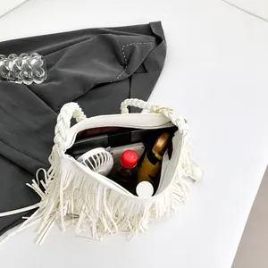 Top view of large white tassel bag interior showing ample storage for daily items