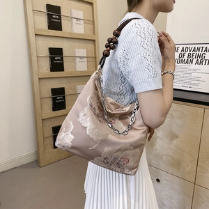 Elegant champagne lace tote bag with floral embroidery and wooden bead chain strap