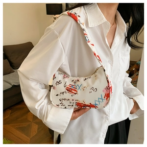 Detail of white nylon underarm bag with artistic colorful graffiti print and zipper