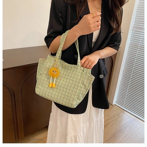 Green and white checkered knit tote bag featuring a cute yellow pompom keychain accessory