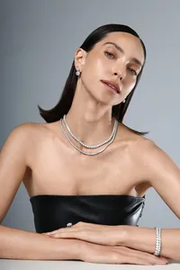 Elegant model wearing a S925 silver moissanite tennis bracelet and jewelry set