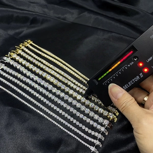 Detail showing Moissanite tennis bracelets in gold and silver being tested with a diamond pen