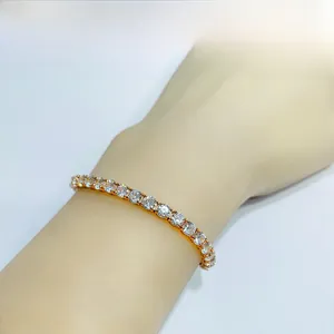 Close-up of rose gold moissanite tennis bracelet on wrist with round white zircons