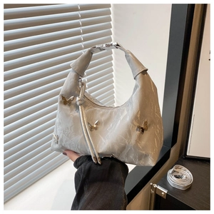 Detail of silver marble PU leather handbag with metallic butterfly charms and top handle