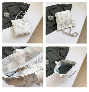 Detailoverzicht van vlinderprint tote tas met ritssluiting en interne opbergruimte