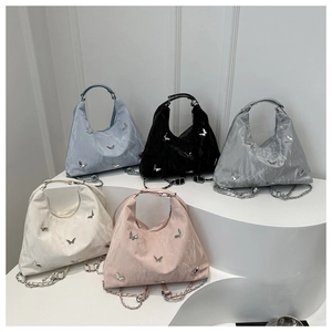 Close-up of stylish large tote bags in five colors with metallic butterfly charms