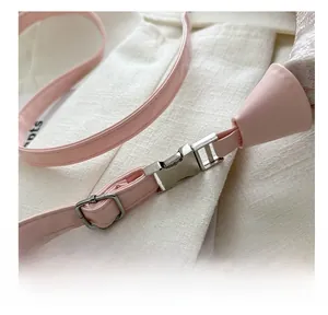 Detailed close-up of pink leather shoulder strap with silver buckle and hardware