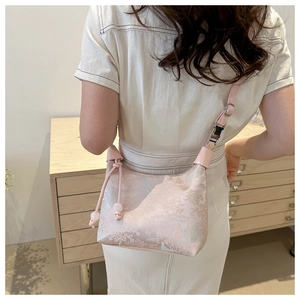 Detail of light pink jacquard bag showing mountain texture and white bead drawstring