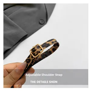 Close-up of leopard print adjustable shoulder strap with premium gold metal buckle