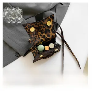 Internal capacity of leopard print small square bag holding lipstick and cosmetics