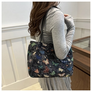 Close-up of butterfly jacquard canvas tote bag with slim black leather shoulder straps
