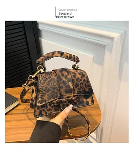 Detail of leopard brown hourglass handbag showing gold hardware and animal print texture