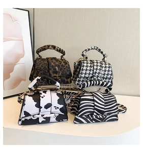 Mini handbags in leopard, zebra, and houndstooth patterns with matching thick top handles