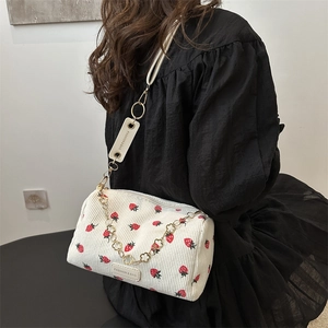 Fashionable off-white corduroy shoulder bag with strawberry print and floral gold chain