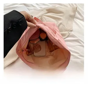 Internal view showing spacious storage capacity and zipper of the pink nylon tote bag