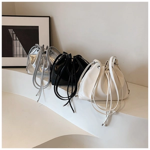 Detailed view of large capacity drawstring bucket bags in silver, black, and creamy white colors