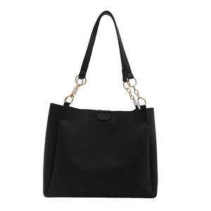 Large black tote bag with lychee texture and gold chain strap on white background