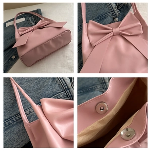 Dettaglio della borsa rosa con fiocco, chiusura magnetica e trama delle cuciture