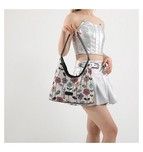 Floral print canvas hobo bag with vintage flowers and black leather handle detail