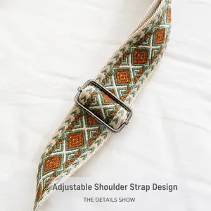 Detail of adjustable woven shoulder strap with geometric patterns and silver buckle