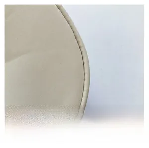Macro detail of high-quality textile fabric and smooth stitching on the beige handbag