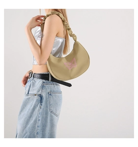 Detail of khaki hobo bag with pink butterfly embroidery and pleated scrunchie strap