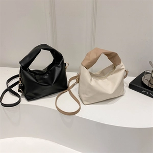 Minimalist pleated square handbag with wide top handle in black and two-tone beige design