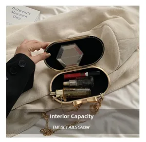 Internal capacity of gold evening clutch bag showing lipstick and makeup storage space