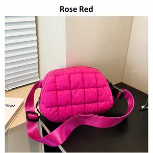Vista dettagliata della borsa a tracolla imbottita rosa con cinturino in nylon su nero