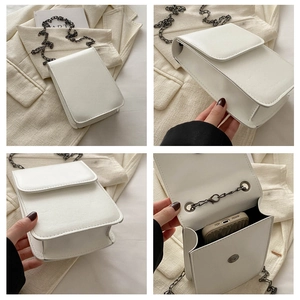 Detail of white PU leather crossbody bag showing chain strap and internal phone pocket