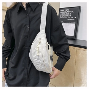 Détail du sac de poitrine blanc en nylon avec broderie 3D et cordons décoratifs tressés