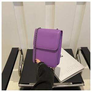 Close-up of purple PU leather phone bag with magnetic flap and dark grey metal chain strap