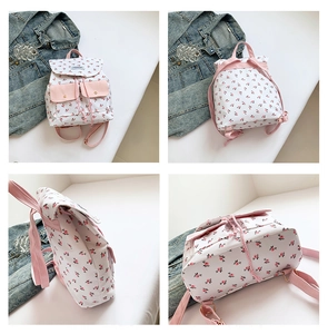 Multi-angle views of a white floral canvas backpack with pink accents and metal buckles