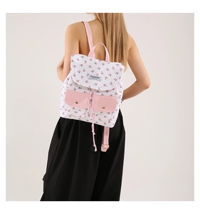 Floral canvas backpack with pink accents shown from a back view on a model