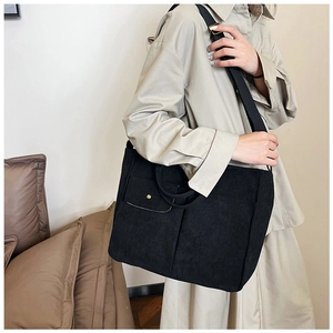Détail du sac cabas en velours côtelé noir avec grande capacité et bandoulière réglable