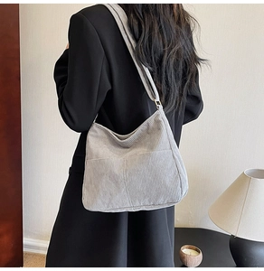 Detail view of a vintage corduroy tote bag in light grey with a front pocket design