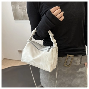 Close-up of pleated handle and marble texture on white mini PU shoulder bag with silver chain